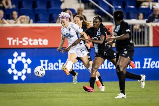 Megan Rapinoe of OL Reign is covered by Mandy Freeman of NJ/NY Gotham FC and two other defenders during the second half of the match against NJ/NY...