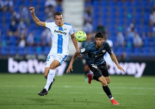 Kevin Bua of CD Leganes competes for the ball with Mario Hernandez of Rayo Vallecano during the Liga Smartbank Playoffs match between CD Leganes and...