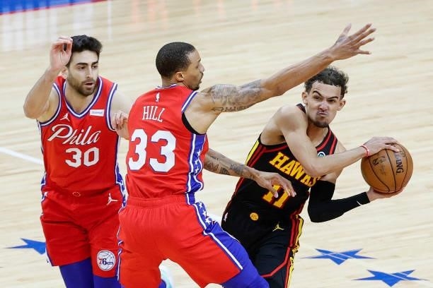 Trae Young of the Atlanta Hawks looks to pass past George Hill of the Philadelphia 76ers during the fourth quarter during Game One of the Eastern...