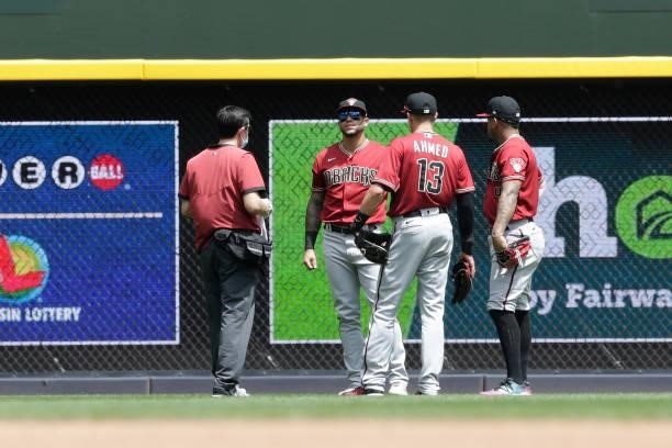 David Peralta of the Arizona Diamondbacks gets looked at by trainers after a diving catch in the second inning against the Milwaukee Brewers at...