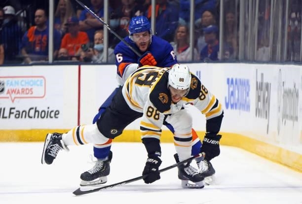 Ryan Pulock of the New York Islanders checks David Pastrnak of the Boston Bruins in Game Four of the Second Round of the 2021 NHL Stanley Cup...