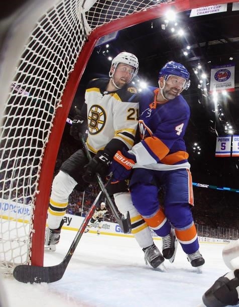 Nick Ritchie of the Boston Bruins battles for position with Andy Greene of the New York Islanders in Game Four of the Second Round of the 2021 NHL...