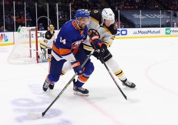 Jeremy Lauzon of the Boston Bruins holds back Travis Zajac of the New York Islanders in Game Four of the Second Round of the 2021 NHL Stanley Cup...