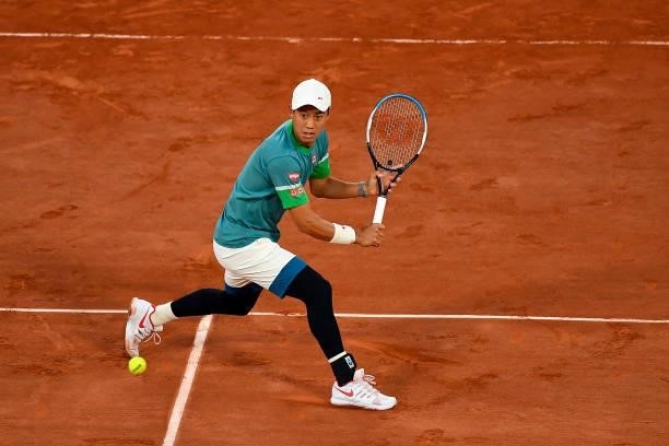Kei Nishikori of Japan plays a backhand during his Men's Singles fourth round match against Alexander Zverev of Germany on day eight of the 2021...