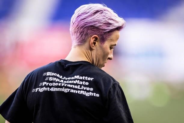 Megan Rapinoe of OL Reign wears a tee shirt that says on the back #BlackLivesMattter #StopAsianHate #ProtectTransLives and #Fight4ImmigrantRights as...