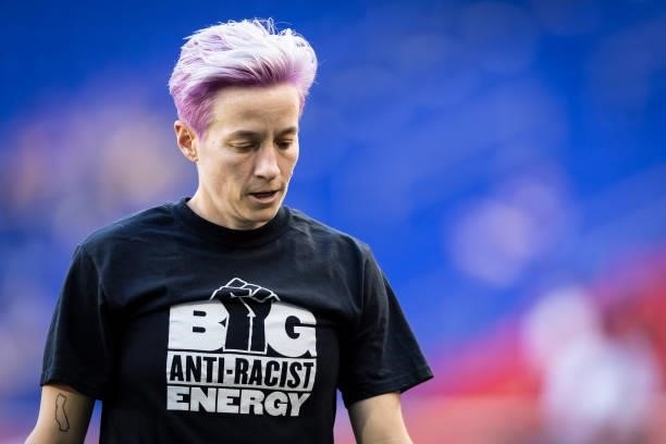 Megan Rapinoe of OL Reign wears a tee shirt that says Big Anti-Racist Energy with a Black Power Fist on it as she warms up before the match against...