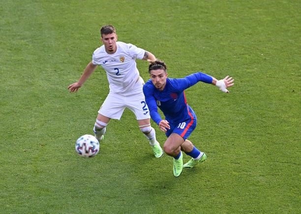 Jack Grealish of England battles for possession with Tiberiu Capusa of Romania during the international friendly match between England and Romania at...