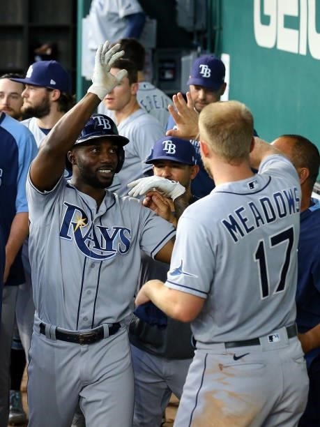 Randy Arozarena of the Tampa Bay Rays is greeted in the dugout by Austin Meadows of the Tampa Bay Rays after scoring in the eighth inning against the...