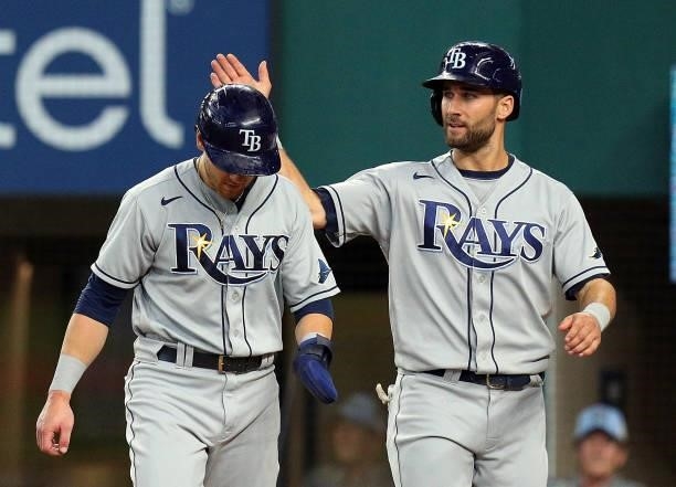 Mike Brosseau and Kevin Kiermaier of the Tampa Bay Rays celebrate after scoring on a single by Austin Meadows of the Tampa Bay Rays in the ninth...