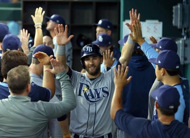 Kevin Kiermaier of the Tampa Bay Rays is greeted in the dugout after scoring in the ninth inning against the Texas Rangers at Globe Life Field on...