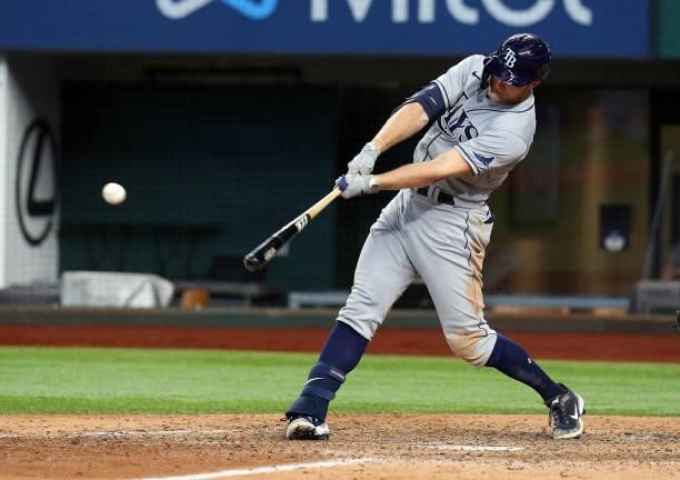 Austin Meadows of the Tampa Bay Rays hits a two-run single in the ninth against the Texas Rangers at Globe Life Field on June 06, 2021 in Arlington,...