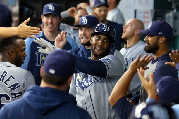 Yandy Diaz of the Tampa Bay Rays is greeted in the dugout after his two-run home run against the Texas Rangers in the ninth inning at Globe Life...
