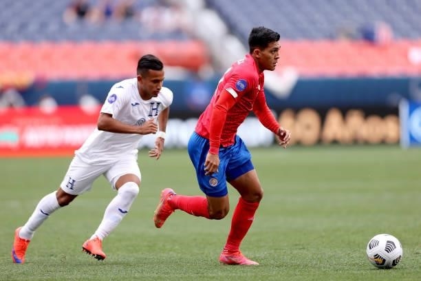 Alonso Martinez of Costra Rica advances the ball against Edwin Rodriguez of Honduras in the first half during the third place match of the Finals of...