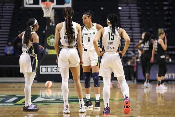 Arike Ogunbowale, Isabelle Harrison, Satou Sabally and Allisha Gray of the Dallas Wings have a conversation on the court during the second quarter of...