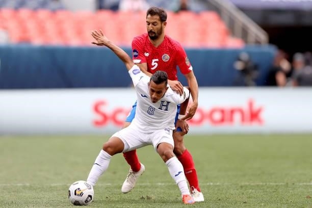 Edwin Rodriguez of Honduras fights for control of the ball aganst Celso Borges of Costra Rica in the first half during the third place match of the...