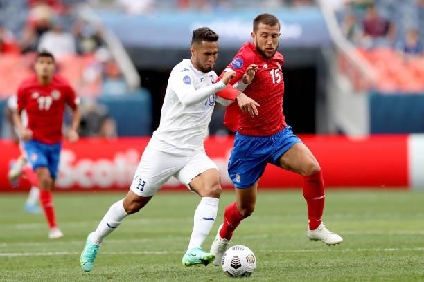 Alexander Lopez of Honduras fights for control of the ball aganst Francisco Calvo of Costra Rica in the second half during the third place match of...