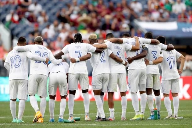 Members of the Honduras team link arms during penalty kicks against Costra Rica in the penalty kick stage to break the tie in regulation during the...