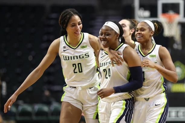 Arike Ogunbowale of the Dallas Wings celebrates with teammates after making a three-point basket during the final seconds of play to defeat the...