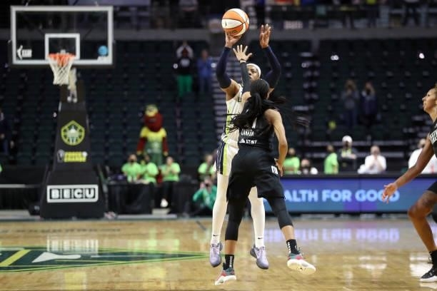 Arike Ogunbowale of the Dallas Wings shoots the game-winning three-point basket over Jordin Canada of the Seattle Storm to defeat the Storm 68-67 at...