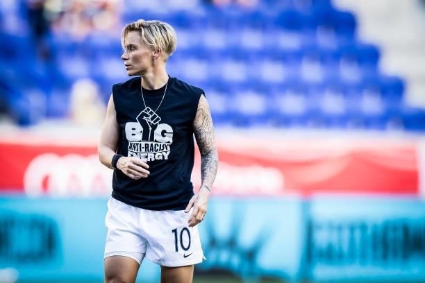 Jessica Fishlock of OL Reign wears a tee shirt that says Big Anti-Racist Energy with a Black Power Fist on it as she warms up before the match...