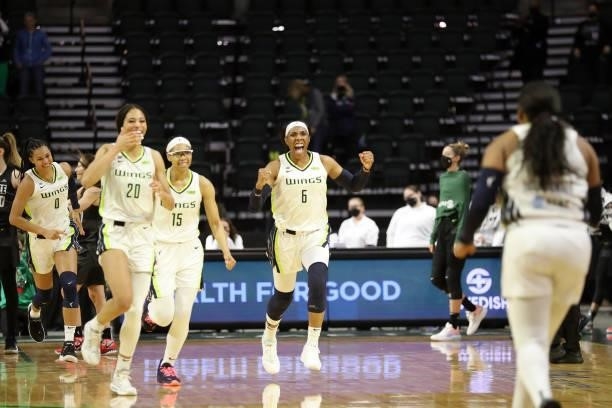 Satou Sabally, Isabelle Harrison, Allisha Gray, Kayla Thornton and Arike Ogunbowale of the Dallas Wings celebrate after defeating the Seattle Storm...