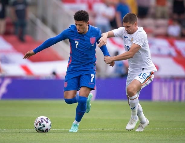 Jadon Sancho of England and Razvan Marin of Romania in action during the international friendly match between England and Romania at Riverside...