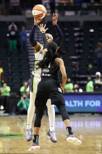 Arike Ogunbowale of the Dallas Wings shoots the game-winning three point basket over Jordin Canada of the Seattle Storm to defeat the Storm 68-67 at...