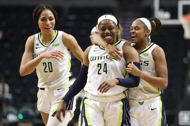 Arike Ogunbowale of the Dallas Wings celebrates with teammates Isabelle Harrison and Moriah Jefferson after making the game-winning basket during the...