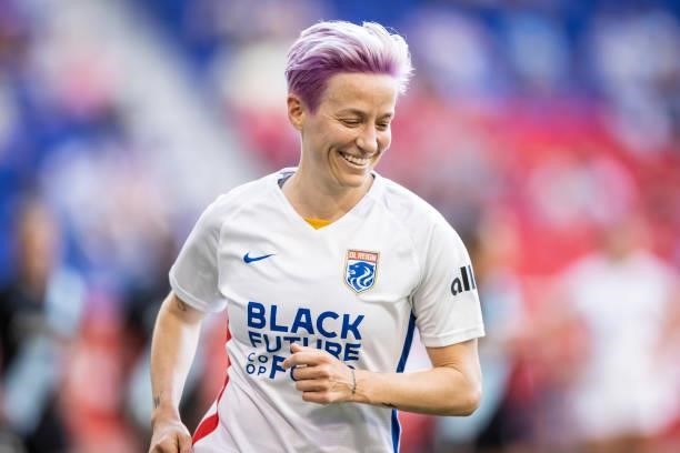 Megan Rapinoe of OL Reign is all smiles as she heads to take a corner kick in the first half of the match against NJ/NY Gotham FC at Red Bull Arena...