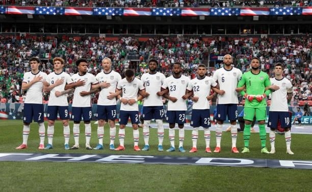 The USA starting eleven stand together arm in arm before the CONCACAF Nations League Championship Final between the United States and Mexico at...