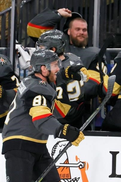 Robin Lehner of the Vegas Golden Knights takes his hat off to throw it on the ice as Jonathan Marchessault celebrates with teammates on the bench...