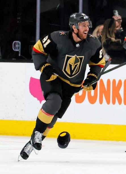 Jonathan Marchessault of the Vegas Golden Knights celebrates as he skates past a hat thrown onto the ice by fans after he scored a third-period goal,...