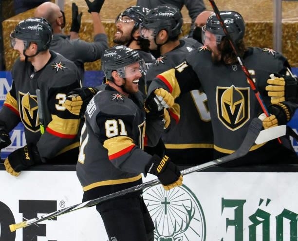 Jonathan Marchessault of the Vegas Golden Knights celebrates with teammates on the bench after he scored a third-period goal, his third goal of the...
