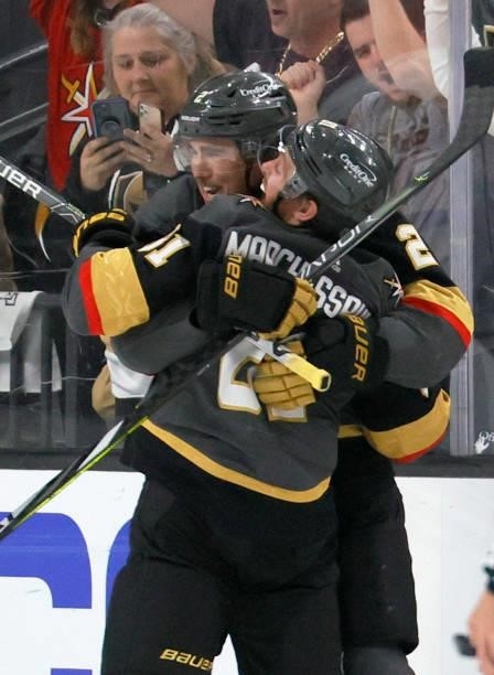 Zach Whitecloud of the Vegas Golden Knights hugs Jonathan Marchessault after he scored a third-period goal, his third of the game, against the...