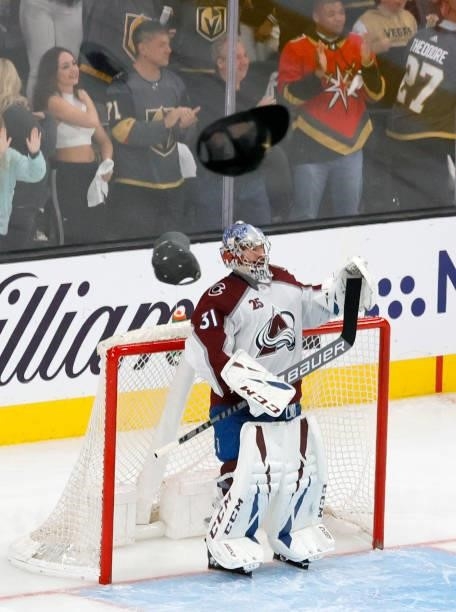 Philipp Grubauer of the Colorado Avalanche stands in front of his net as hats thrown by fans rain down on the ice after Jonathan Marchessault of the...