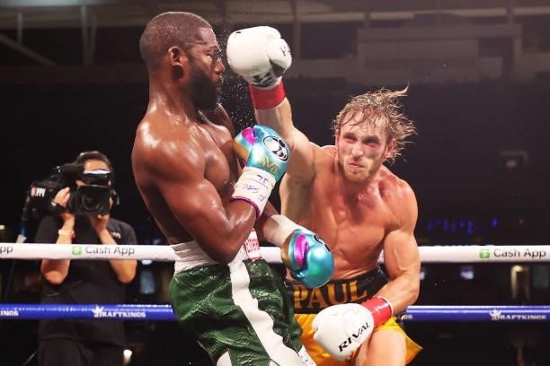 Floyd Mayweather is punched by Logan Paul during their contracted exhibition boxing match at Hard Rock Stadium on June 06, 2021 in Miami Gardens,...