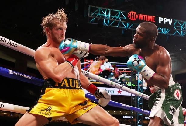 Floyd Mayweather punches Logan Paul during their contracted exhibition boxing match at Hard Rock Stadium on June 06, 2021 in Miami Gardens, Florida.