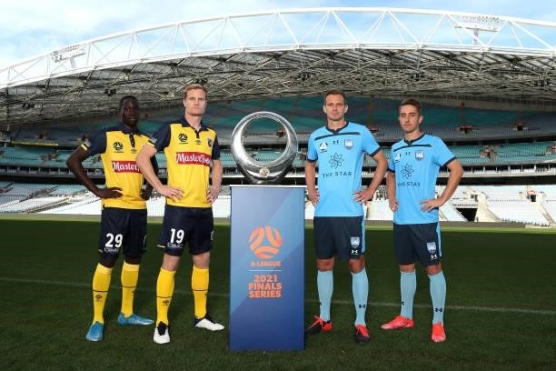 Alex Wilkinson and Joel King of Sydney FC and Matt Simon and Alou Kuol of Central Coast Mariners pose with the A-League trophy during the 2021...