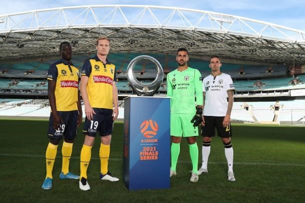 Matt Simon and Alou Kuol of Central Coast Mariners and Adam Federici and Matt Derbyshire of Macarthur FC pose with the A-League trophy during the...
