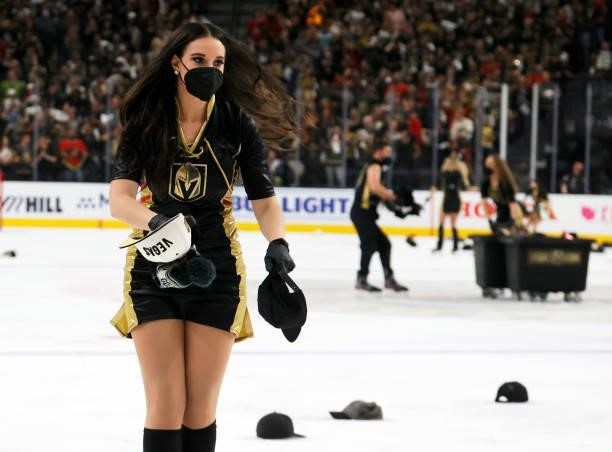 Member of the Knights Guard collects hats thrown on the ice after Jonathan Marchessault of the Vegas Golden Knights scored his third goal of the game...
