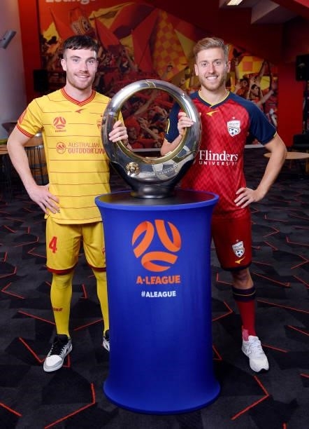 Ryan Strain and Stefan Mauk of Adelaide United with the clubs 2016 A -League Champions Trophy during the 2021 A-League Finals Launch at Coopers...