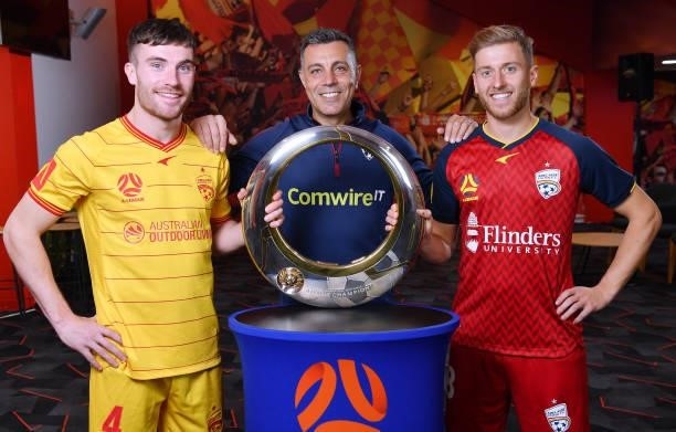 Ryan Strain of Adelaide United ,Ross Aloisi and Stefan Mauk of Adelaide United with the clubs 2016 A -League Champions Trophy during the 2021...