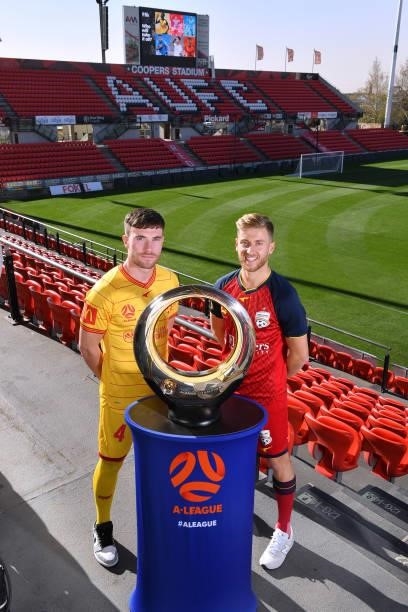 Ryan Strain of Adelaide United and Stefan Mauk of Adelaide United with the clubs 2016 A -League Champions Trophy during the 2021 A-League Finals...
