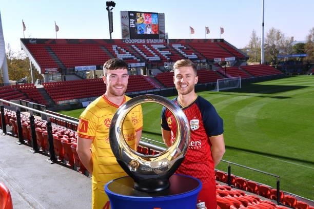 Ryan Strain of Adelaide United and Stefan Mauk of Adelaide United with the clubs 2016 A -League Champions Trophy during the 2021 A-League Finals...