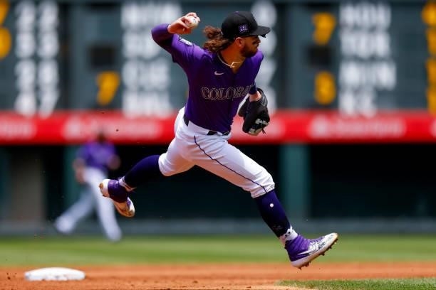 Shortstop Brendan Rodgers of the Colorado Rockies fields a ground ball barehanded before making a throw to first base for an out during the second...