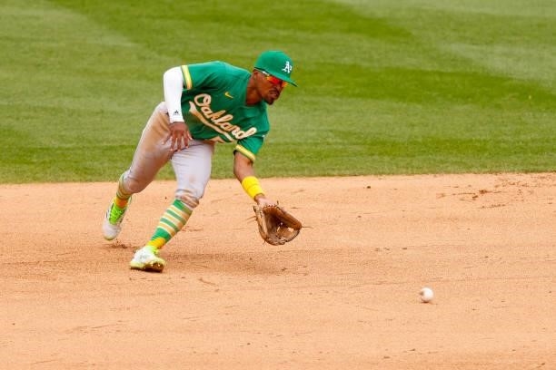 Tony Kemp of the Oakland Athletics fields a ground ball during the fifth inning against the Colorado Rockies at Coors Field on June 6, 2021 in...