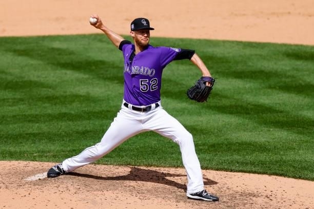 Relief pitcher Daniel Bard of the Colorado Rockies delivers to home plate during the eighth inning against the Oakland Athletics at Coors Field on...