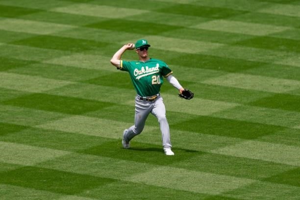 Centerfielder Mark Canha of the Oakland Athletics throws the ball back to the infield during the fourth inning against the Colorado Rockies at Coors...