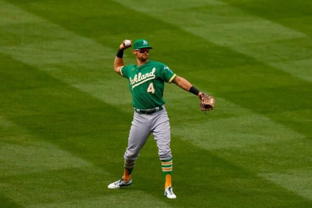 Left fielder Chad Pinder of the Oakland Athletics throws the ball back into the infield during the sixth inning against the Colorado Rockies at Coors...