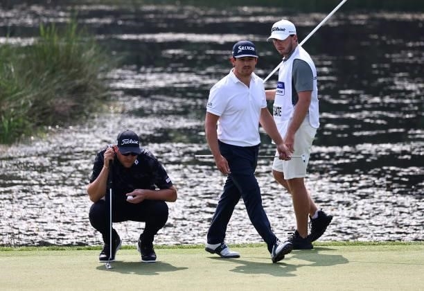 Matthew Southgate of England and Maverick Antcliff of Australia line up their putts on the 7th green during Day Three of The Porsche European Open at...